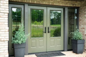 Elegant double glass doors with light green frames and black handles.