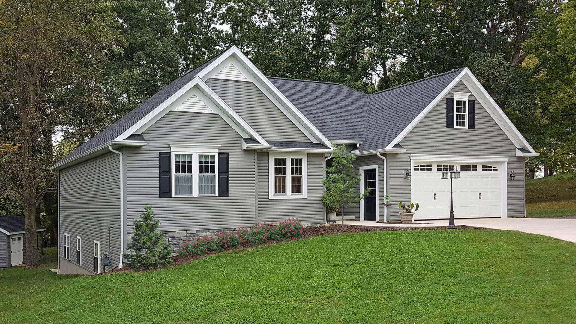 Gray house with a green lawn.