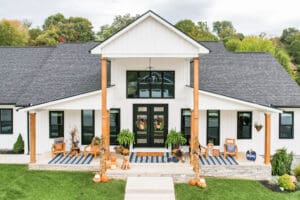 Modern farmhouse with white exterior and black door.
