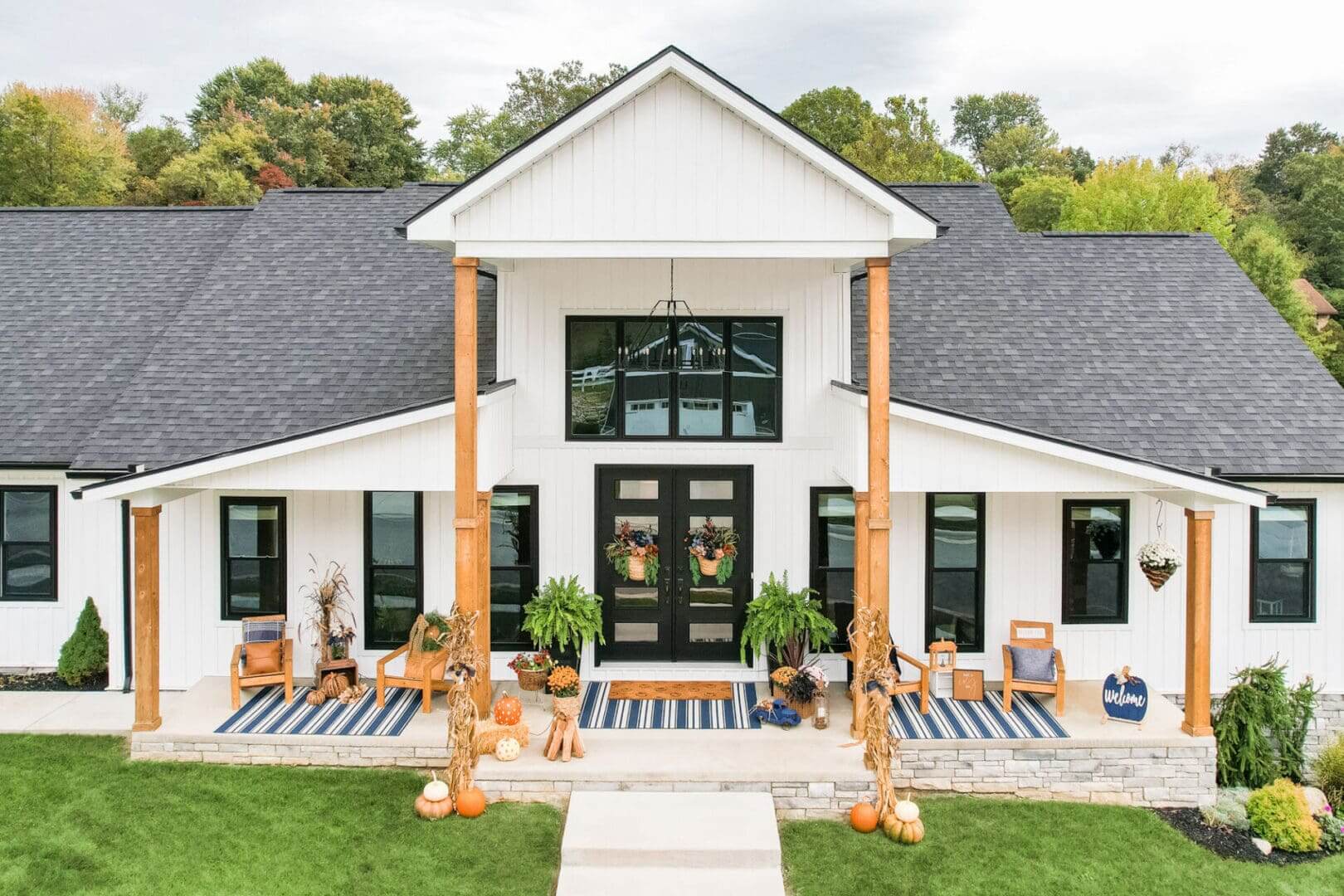 Modern farmhouse with white exterior and black door.