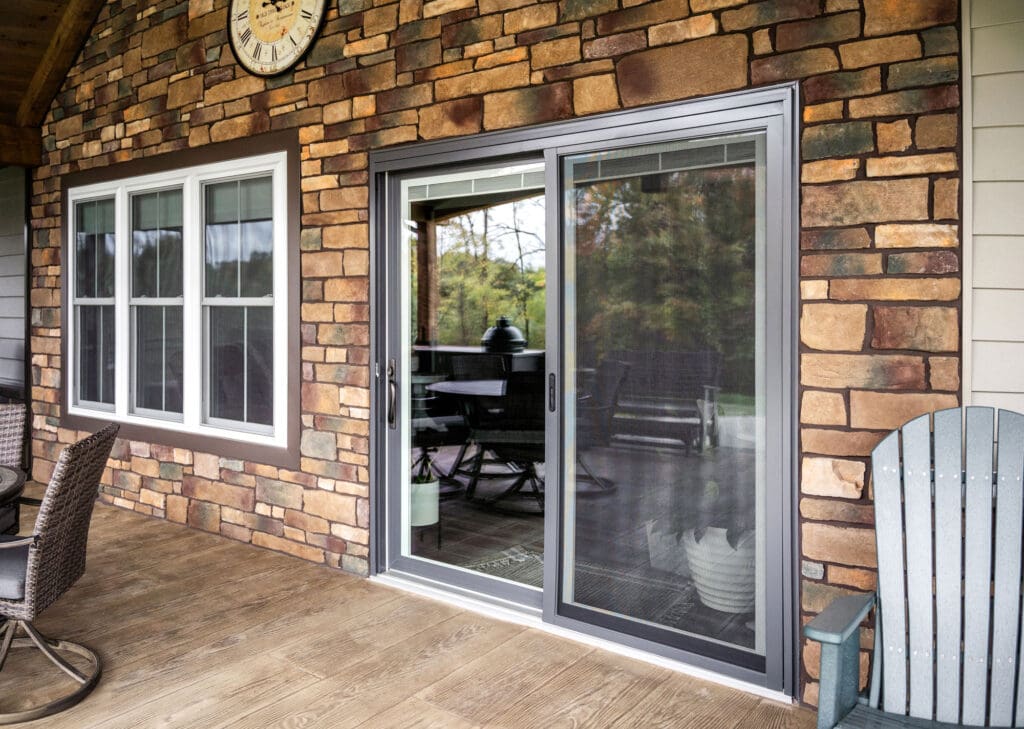 Patio with sliding glass door and chairs.