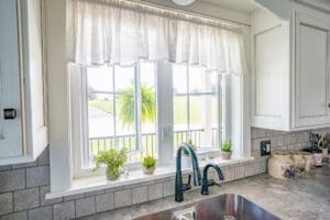 Kitchen sink under window with potted plants