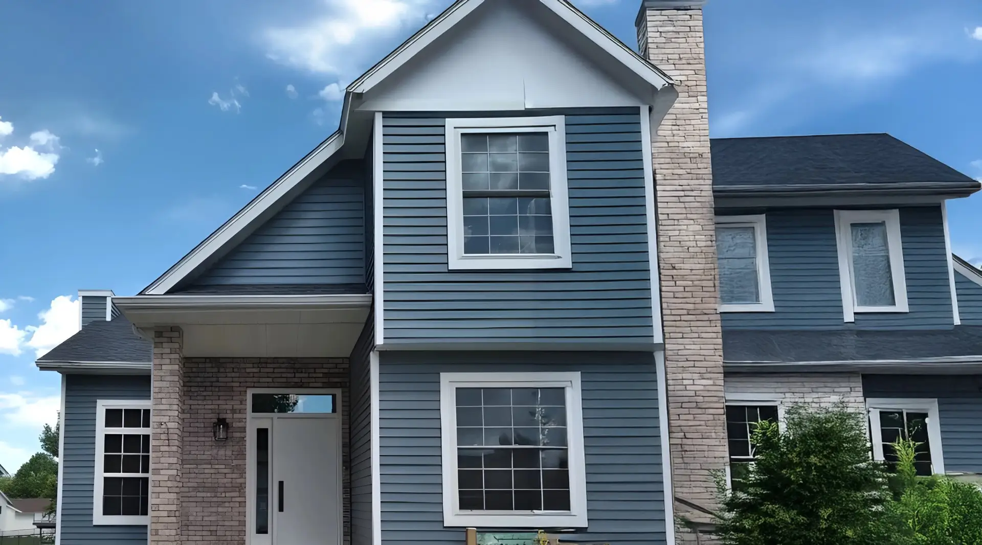 Up close view of the front of a home with the blue sky in the backdrop.