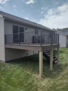 Raised wooden deck with metal railing.