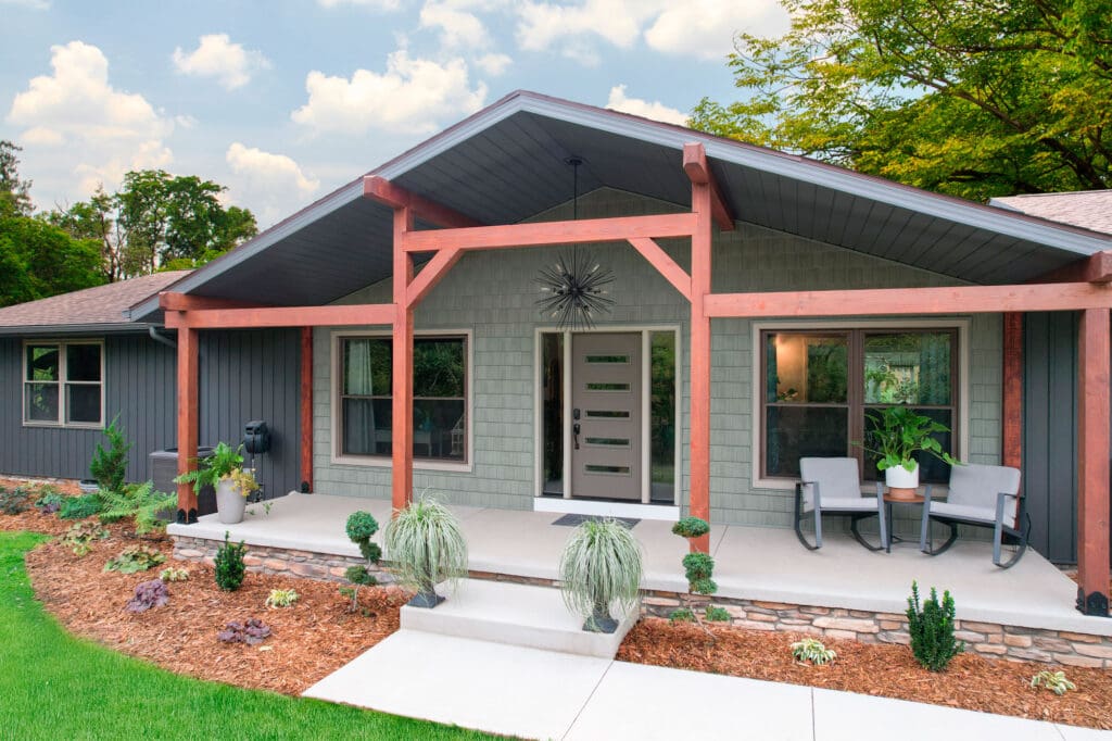 Modern house with wooden porch and landscaping.