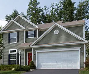 Two-story suburban house with a two-car garage and a red front door.