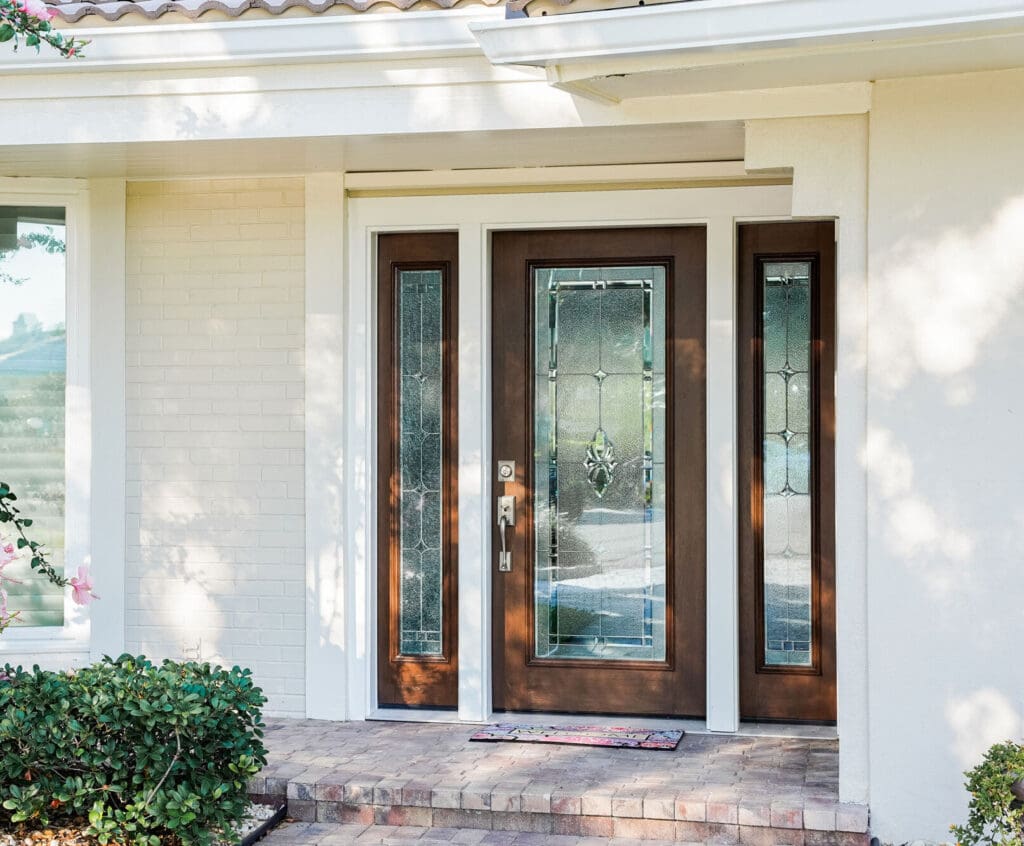 Wooden front door with decorative glass panels.