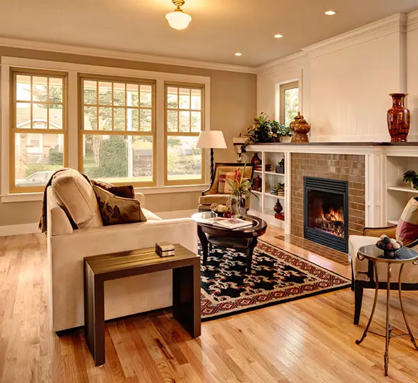 An inside of a room with wooden flooring and white walls.