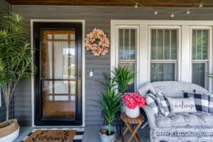 Cozy front porch with wreath, plants, seating