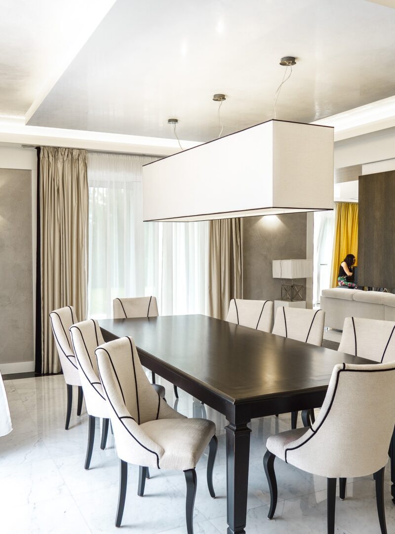 An interior photo of an elegant dining room with a black and white motif.