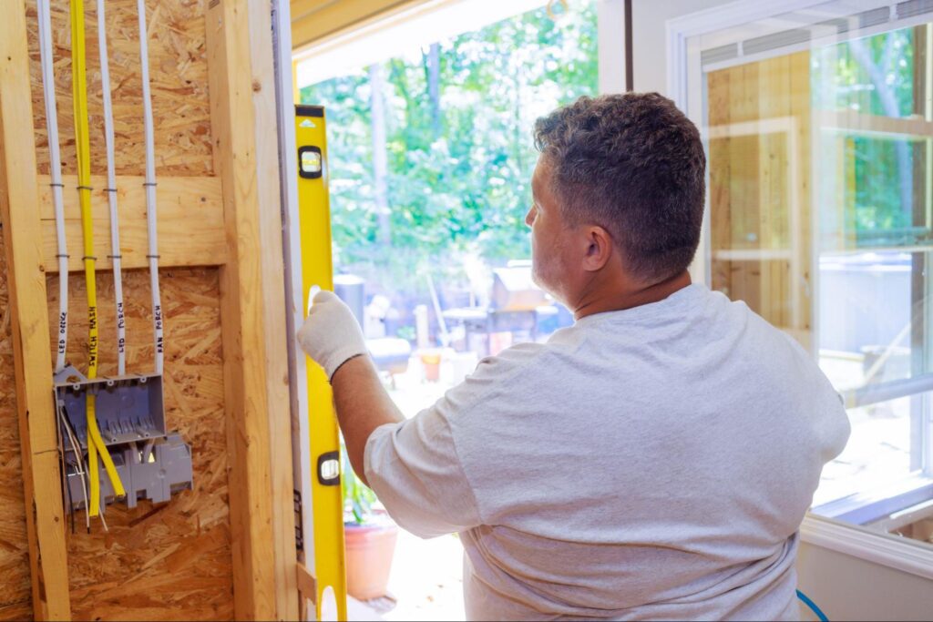 A carpenter installing a new door.