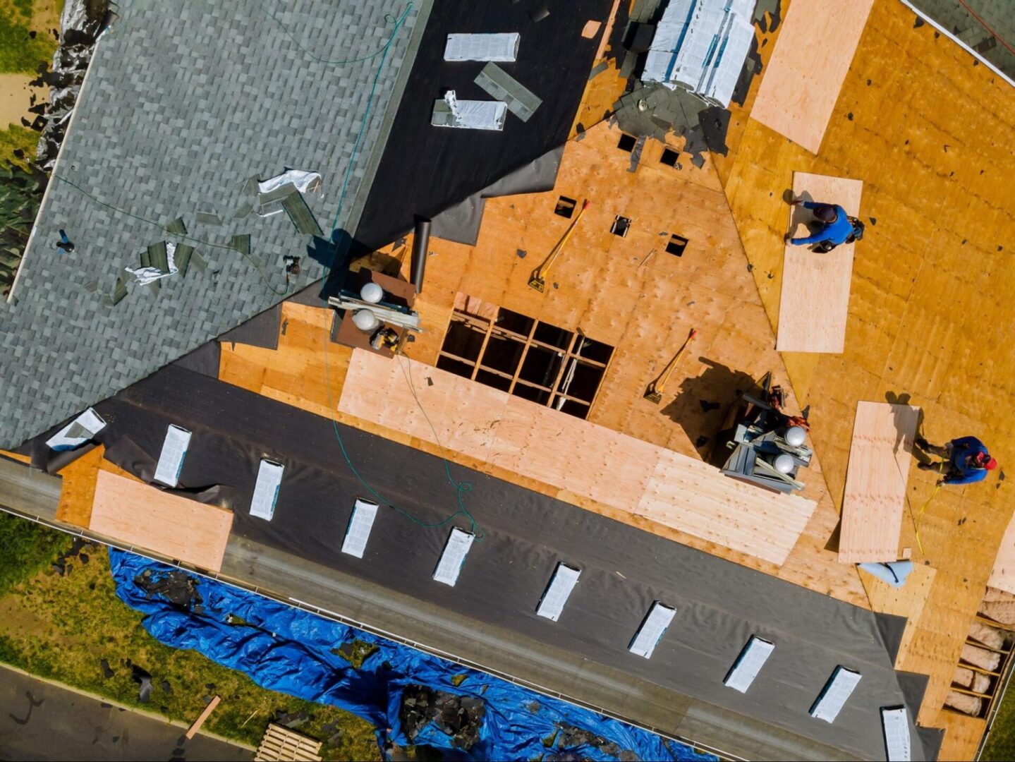 Overhead view of construction workers on a roof. 