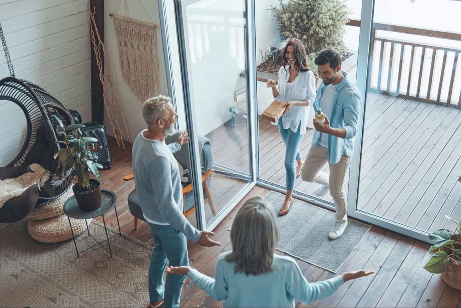 Glass door with a couple walking in next to an elderly couple. 