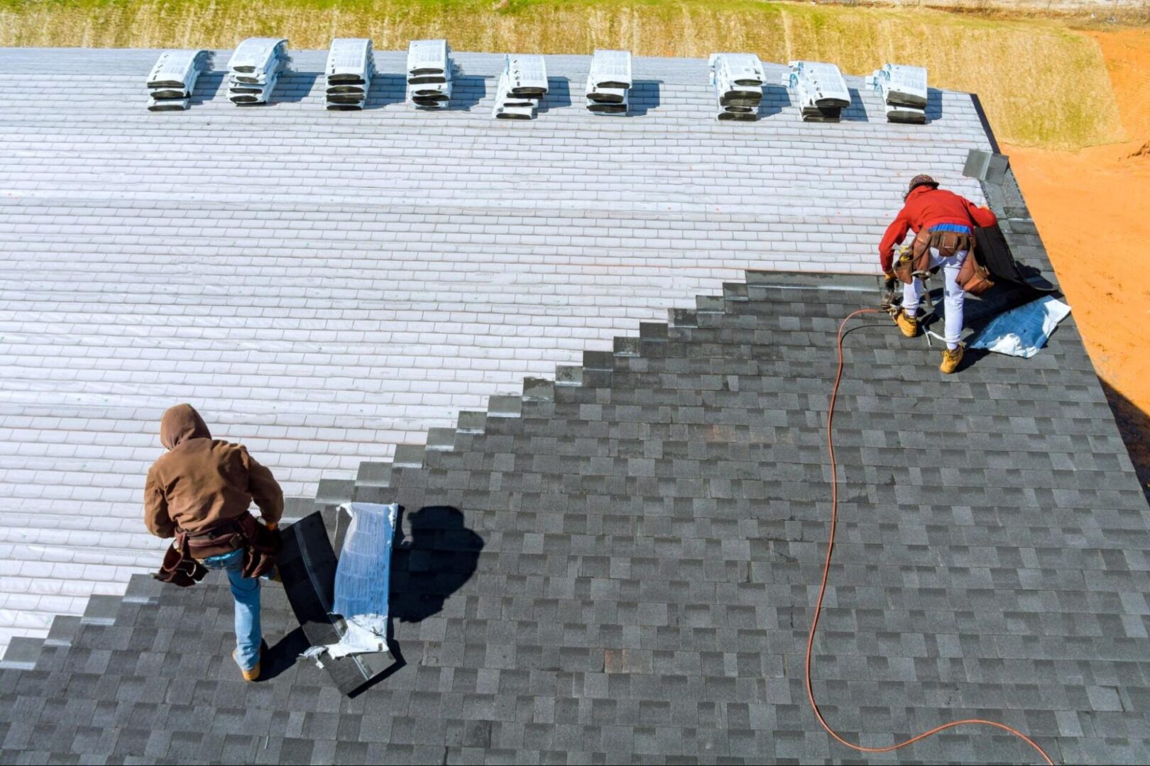 Workers installing a roof. 