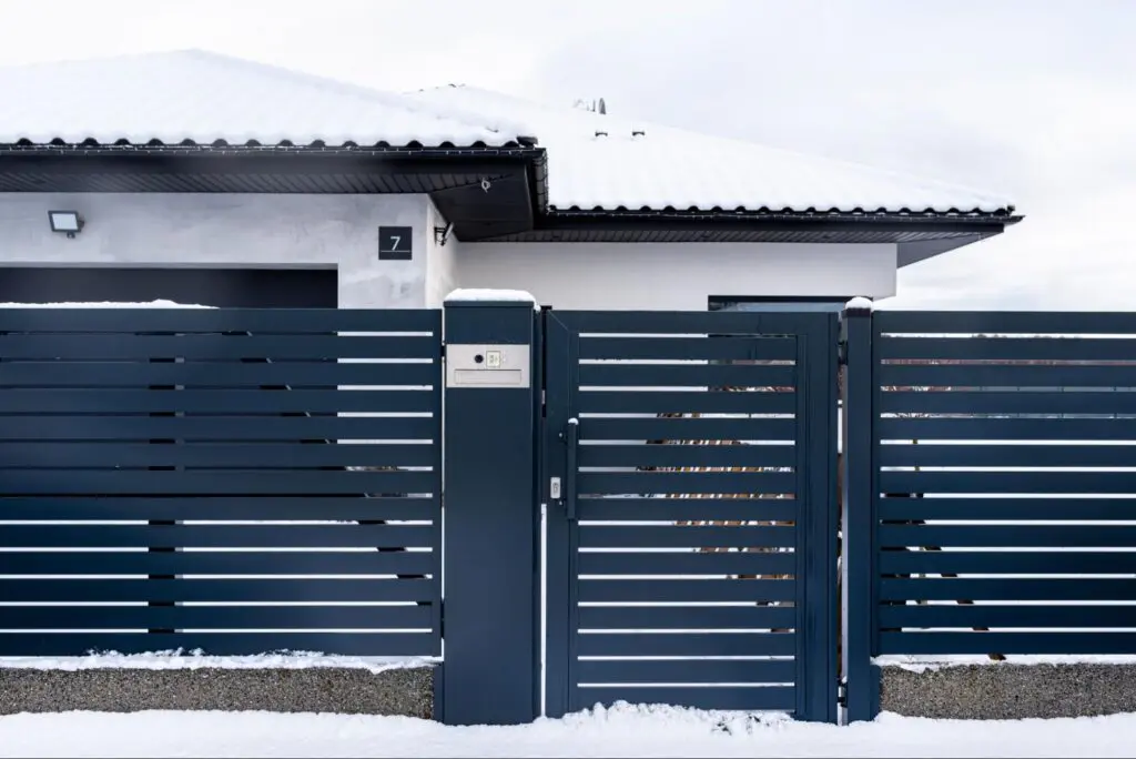 A modern anthracite panel fence featuring a sleek gate, built-in letterbox, and wireless card reader showcasing the best fence ideas for style and functionality.