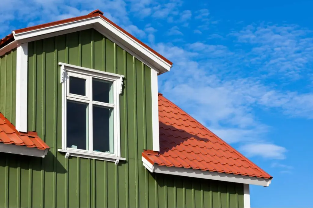 A shot of a house with a vibrant green vertical exterior siding.