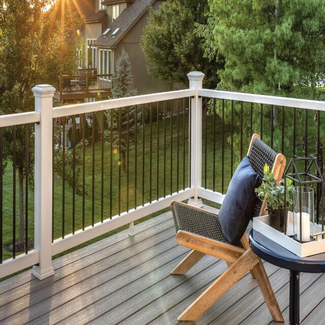 Remodeled patio with a folding chair and a fence. 