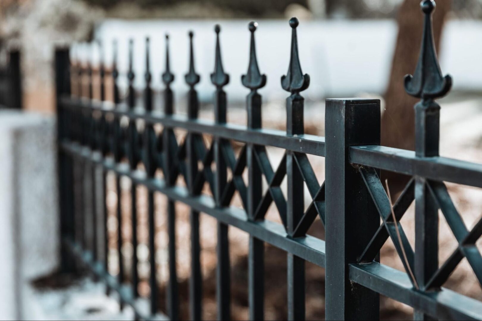 A closeup shot of a black iron fence.