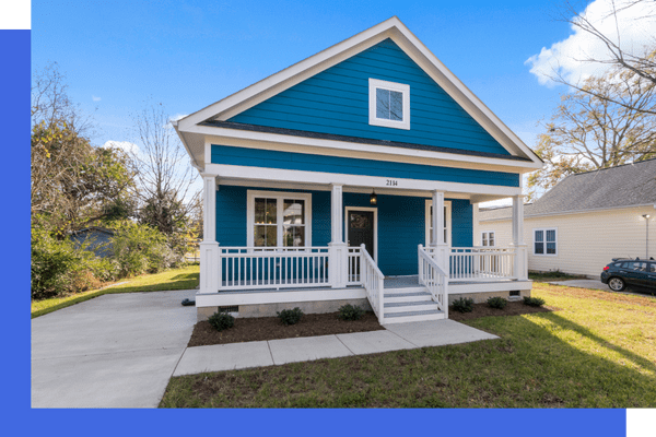 Blue craftsman house with front porch and driveway