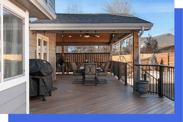 Covered patio with dining table and grill