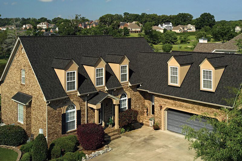 Professional roofing crew installing new asphalt shingles on Kasson MN home