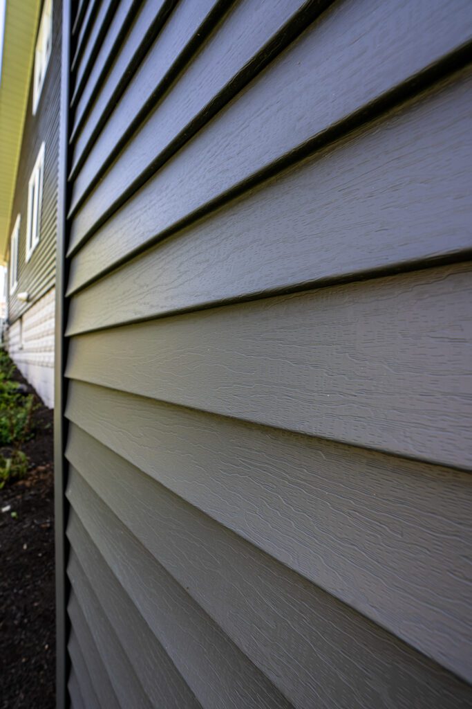 professional siding contractor working on home exterior in Pine Island MN