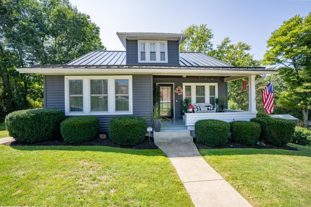 aging siding on residential home showing siding lifespan in Pine Island MN