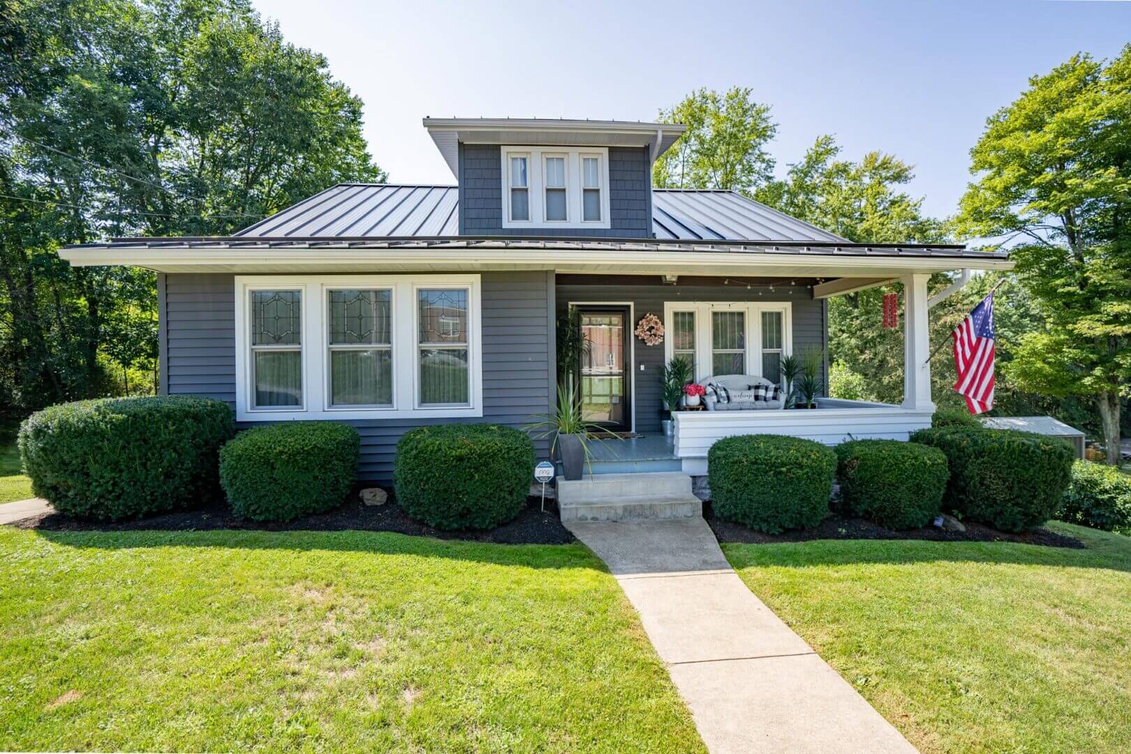 aging siding on residential home showing siding lifespan in Pine Island MN