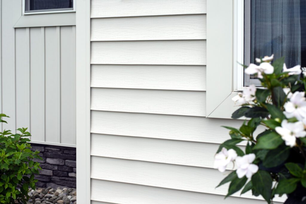 homeowner maintaining siding on residential house in Kasson MN