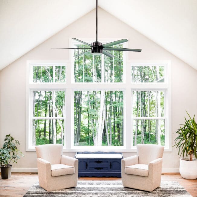 Living room with large forest-view windows