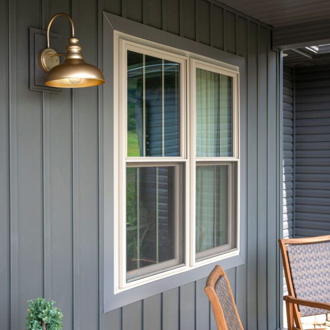 Triple pane replacement window glass close-up showing energy-efficient layers in Kasson MN